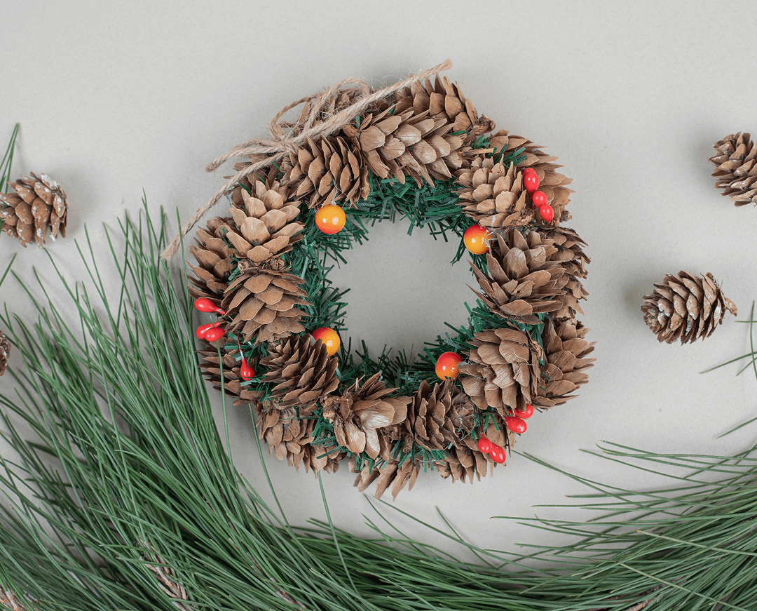 christmas wreath pinecones beige surface