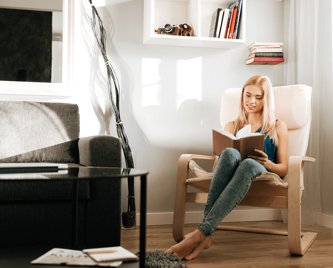 woman sitting reading book home
