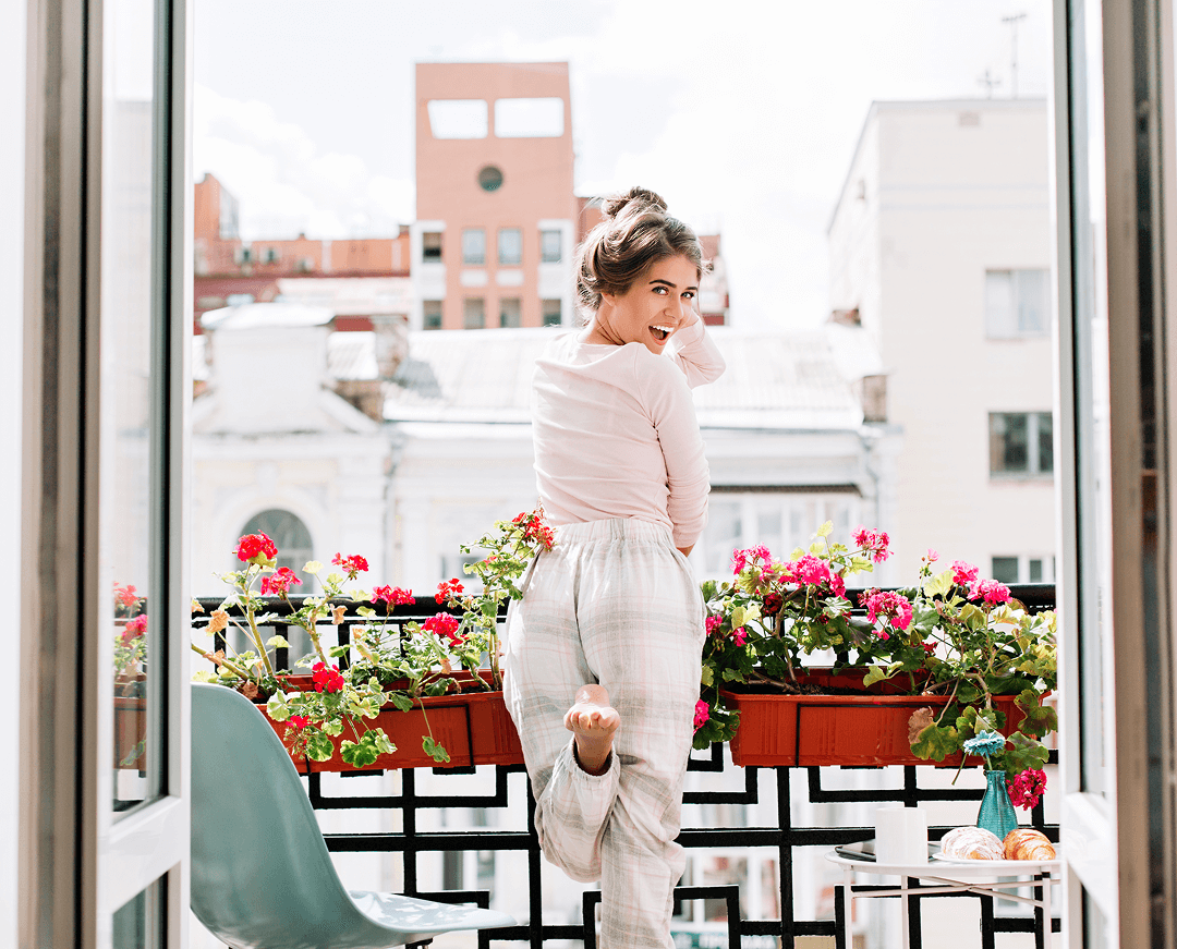 beautiful girl from back pajamas balcony sunny morning she raises leg looks excited camera 1