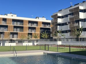 Mediterranean residential building with balconies and gable roof, ideal for vacation or permanent housing.